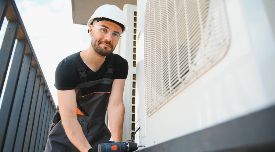 Technician man install new air conditioner, Repairman service for repair and maintenance of air conditioners.